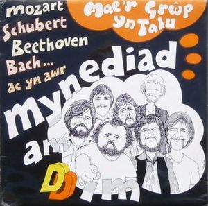 Mae’r Grŵp Yn Talu